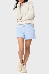 Full body view of Woman modeling Favorite Summer Short in Chambray Herringbone styled with casual sweater and sneakers