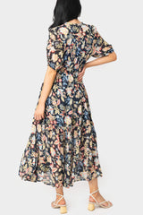 Back of women wearing the Elan Short Sleeve Tiered Floral Midi Dress in navy melrose print