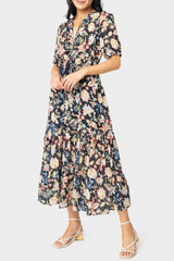 Front of women wearing the Elan Short Sleeve Tiered Floral Midi Dress in navy melrose print