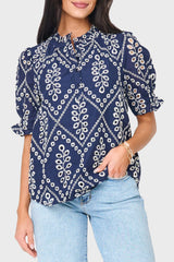 Woman modeling Dianthus Henley Puff Sleeve Eyelet Blouse in navy eyelet styled for work to weekend