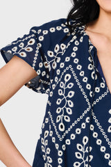 Woman modeling Flutter Sleeve Scallop Top in Navy Eyelet tie neck detail