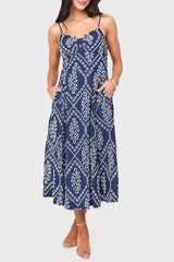 Woman modeling The Amanda Smocked Back Eyelet Midi Dress in navy eyelet styled for summer events and weekends