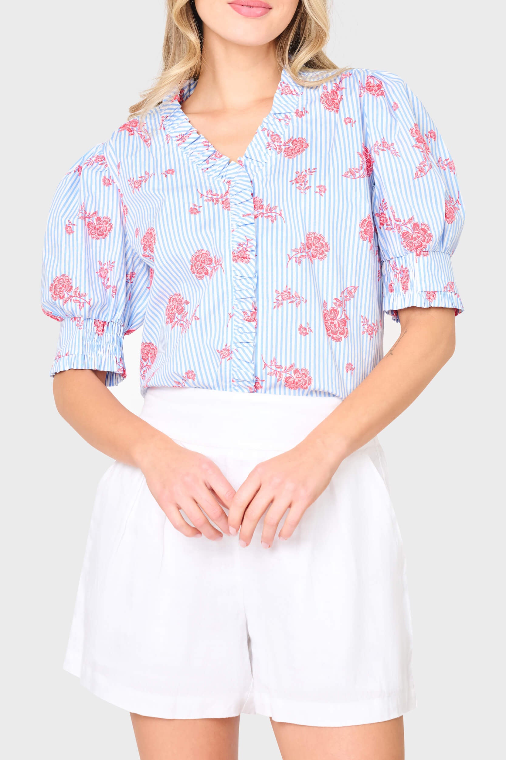 Woman modeling Iris Ruffle Front Button Down Top in Nautical Rose stripe print, styled for summer, vacations, and everyday