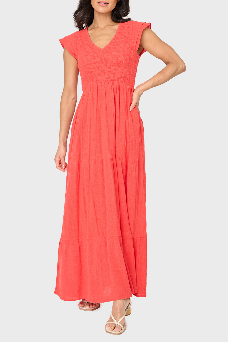 Woman modeling Flutter Sleeve Smocked V-Neck Tiered Maxi Dress in Tangerine Orange styled for work
