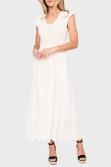 Woman modeling Flutter Sleeve Smocked V-Neck Tiered Maxi Dress in Off White styled for work