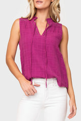 Woman modeling Cameron Day Top with Crochet Trim in Neon Berry styled with casual pants