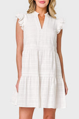 Woman modeling Flutter Sleeve Decked Out Day Dress in White styled for summer travel