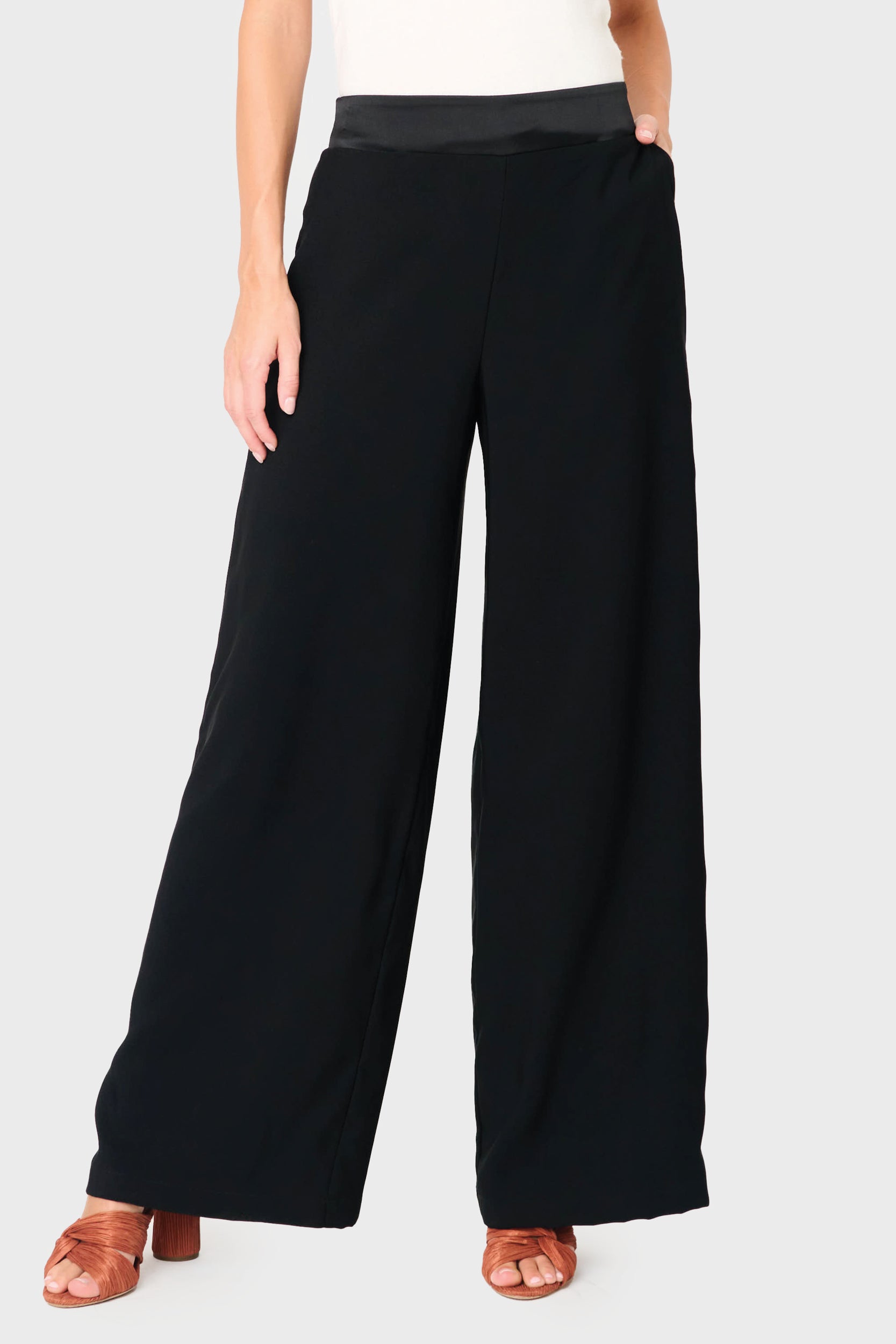 Woman modeling Solstice Satin Trim Pant in Black styled business casual for holiday event