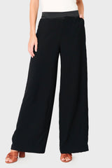 Woman modeling Solstice Satin Trim Pant in Black styled business casual for holiday event