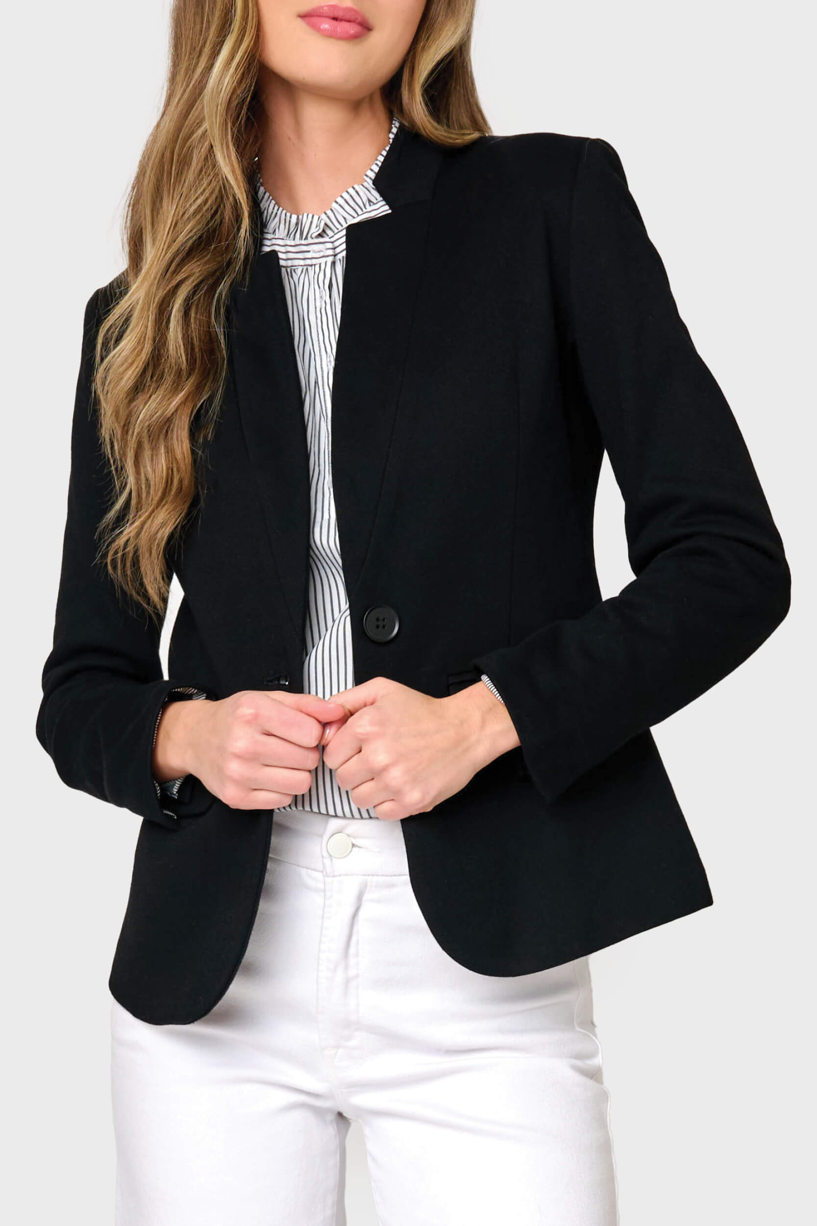 Woman modeling Notch collar knit blazer in Black styled business casual