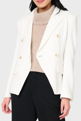 Woman modeling Double Breasted Knit Blazer in White styled business causal for work