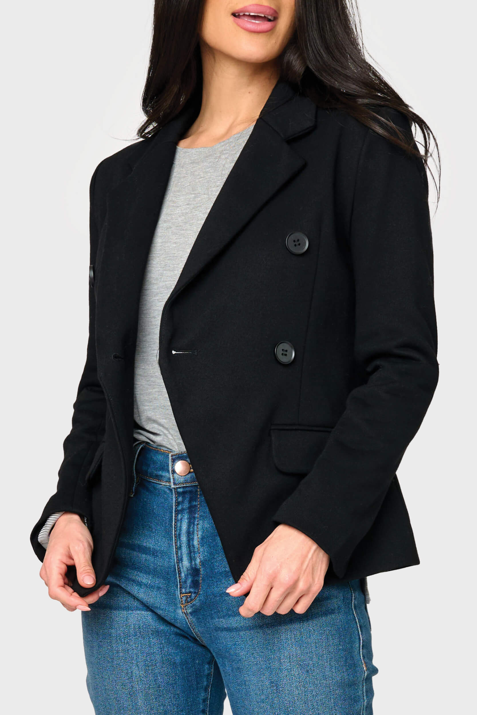 Woman modeling Double Breasted Knit Blazer in Black styled for the office