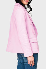 Side view woman modeling Double Breasted Knit Blazer in Pirouette pink styled as a layer