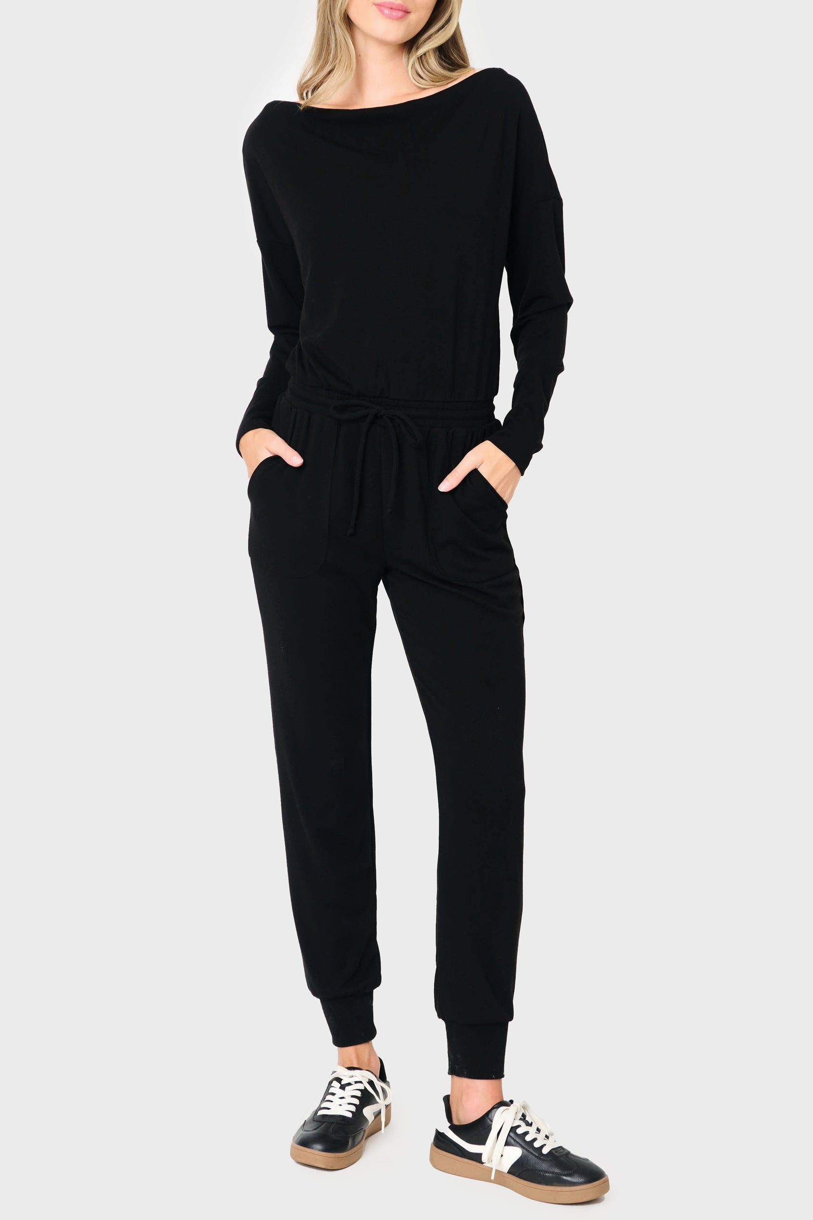 Woman modeling the Off Shoulder Soft Luxe Jumpsuit in black styled casual and cozy