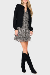 Woman modeling Long Sleeve Isla Smocked Day Dress in Black Cheetah Print  styled for fall night out