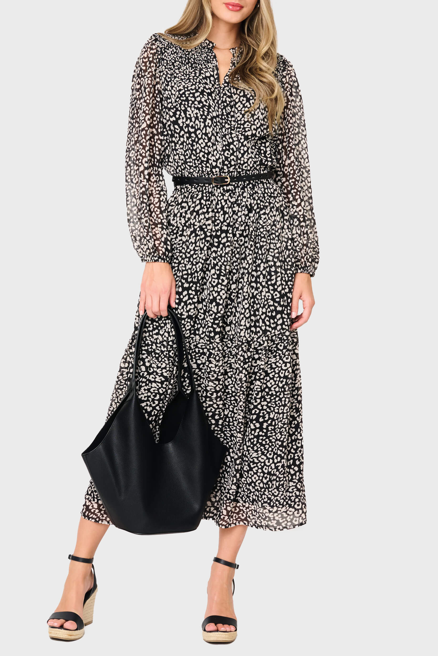 Woman modeling Leyla Smocked Maxi Dress in Black Cheetah print styled business casual