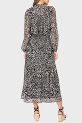 Back of Woman modeling Leyla Smocked Maxi Dress in Black Cheetah print styled business casual