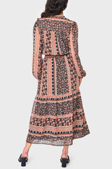 Back of Woman modeling boho Leyla Smocked Maxi Dress in coral black print styled for fall