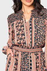 Detail of Woman modeling boho Leyla Smocked Maxi Dress in coral black print, smocked split neck with tie