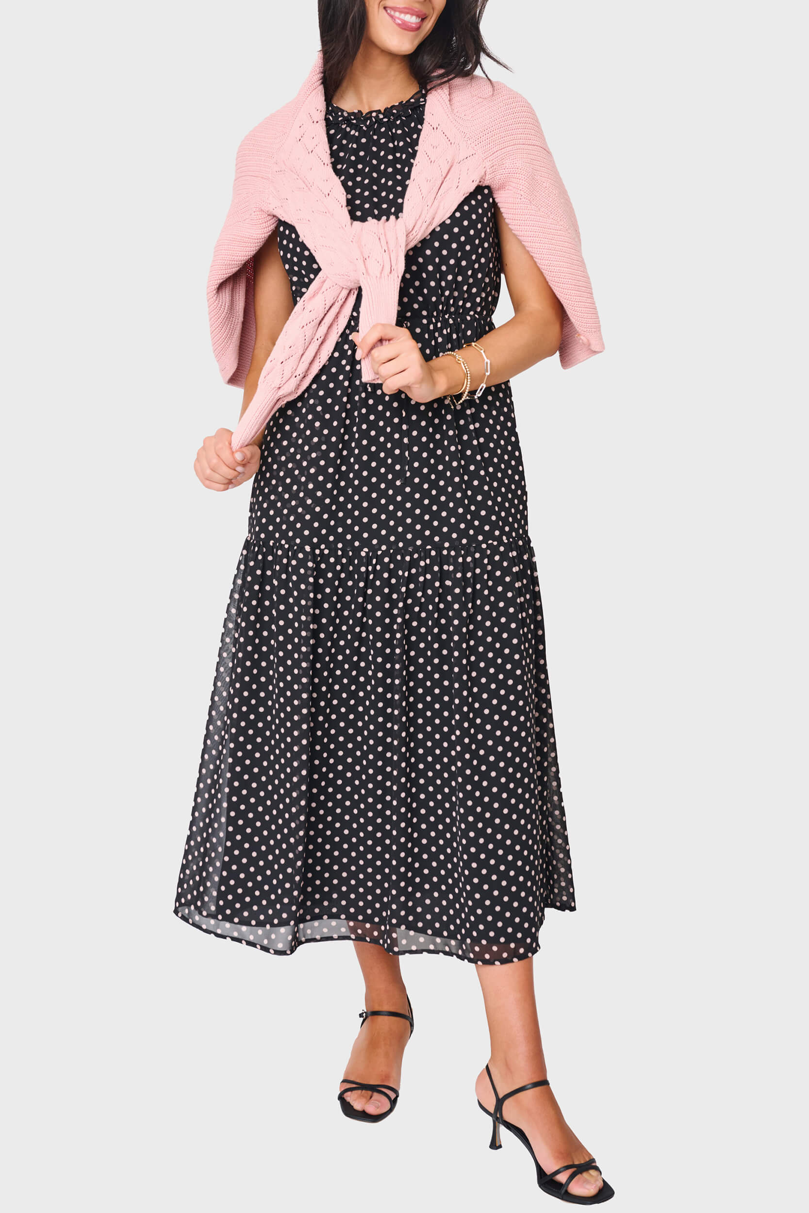 Woman modeling Khloe Maxi Chiffon Dress in Black polka dot styled for work and everyday