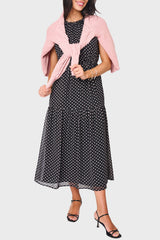 Woman modeling Khloe Maxi Chiffon Dress in Black polka dot styled for work and everyday