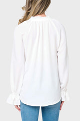 Back view of Woman modeling Chloe Boho Ruffle Detail Blouse in White styled with denim pants
