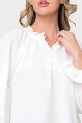 Woman modeling Chloe Boho Ruffle Detail Blouse in White detail of button henley neck