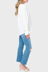 Side view Woman modeling Chloe Boho Ruffle Detail Blouse in White styled with denim pants