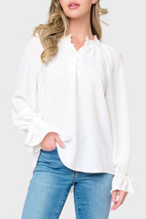 Woman modeling Chloe Boho Ruffle Detail Blouse in White styled with denim pants