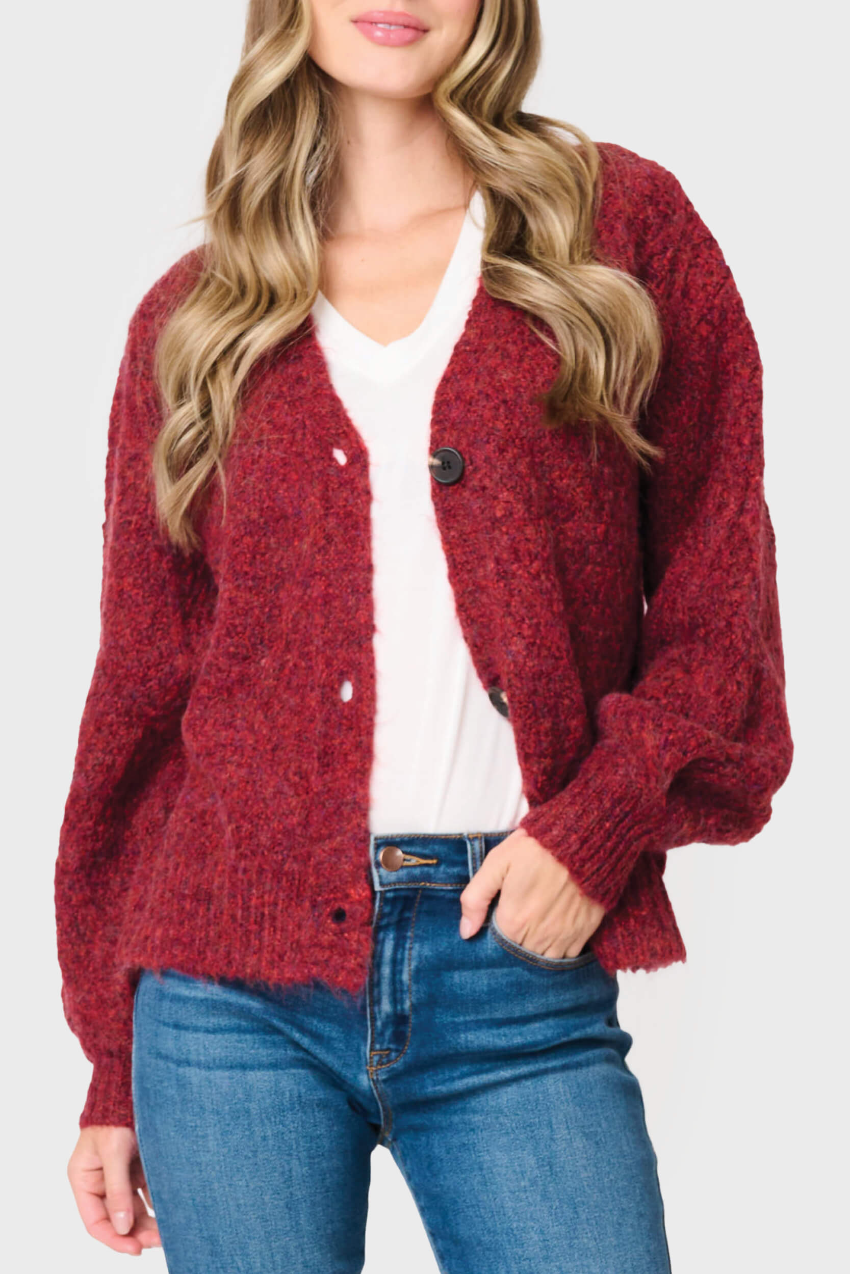 Woman modeling Cable Knit V-Neck Cardigan Sweater in Rose Clay Red styled business casual