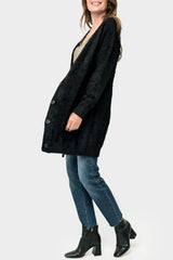Side of Woman wearing Eyelash Boucle Cozy Knee Length Cardigan in Black Onyx