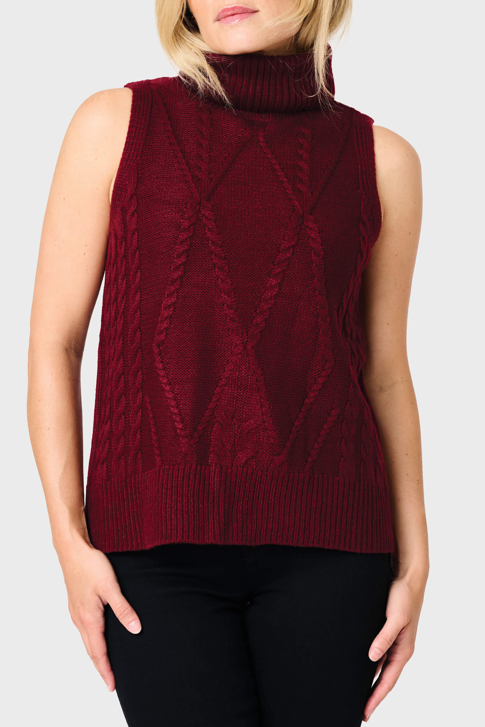 Woman modeling Turtleneck Cable Stitch Sweater Vest in Burgundy red styled for work and everyday