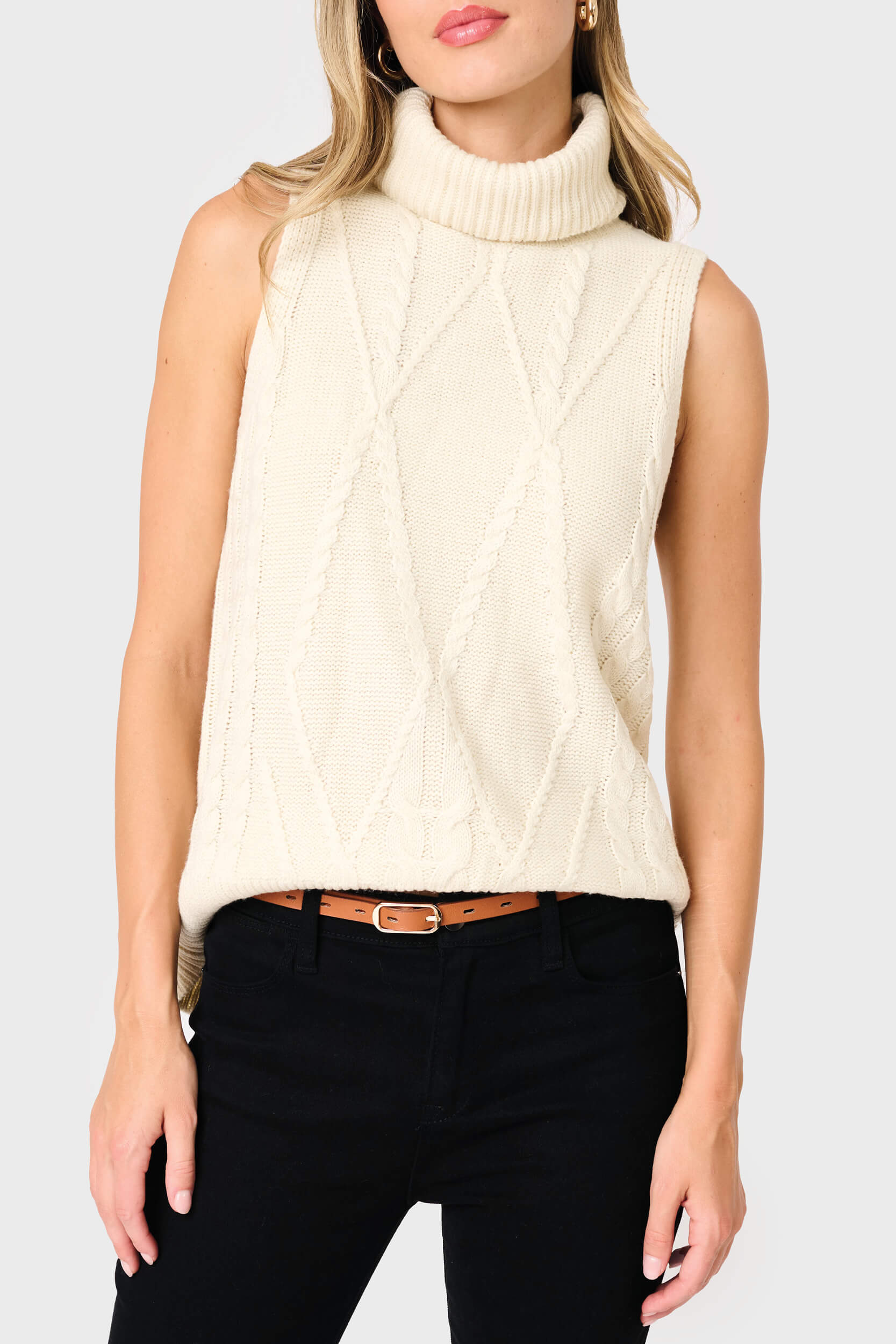 woman modeling Turtleneck Cable Stitch Sweater Vest in cream styled business casual for work