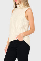 Side of woman modeling Turtleneck Cable Stitch Sweater Vest in cream styled business casual for work