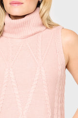 Close-up of a pink knitted sleeveless sweater on a plain background