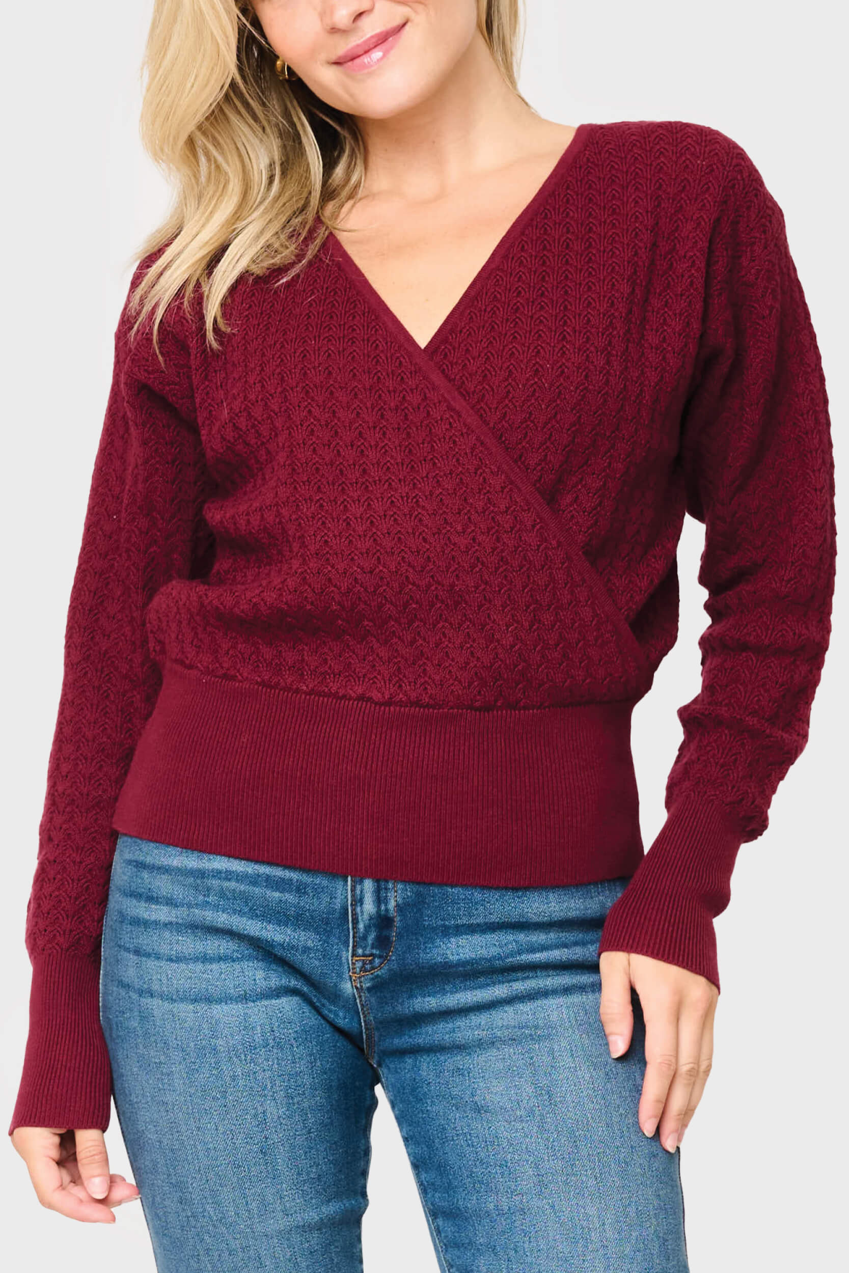 Woman modeling Pointelle Surplice Sweater in Beet Red burgundy styled for everyday and work