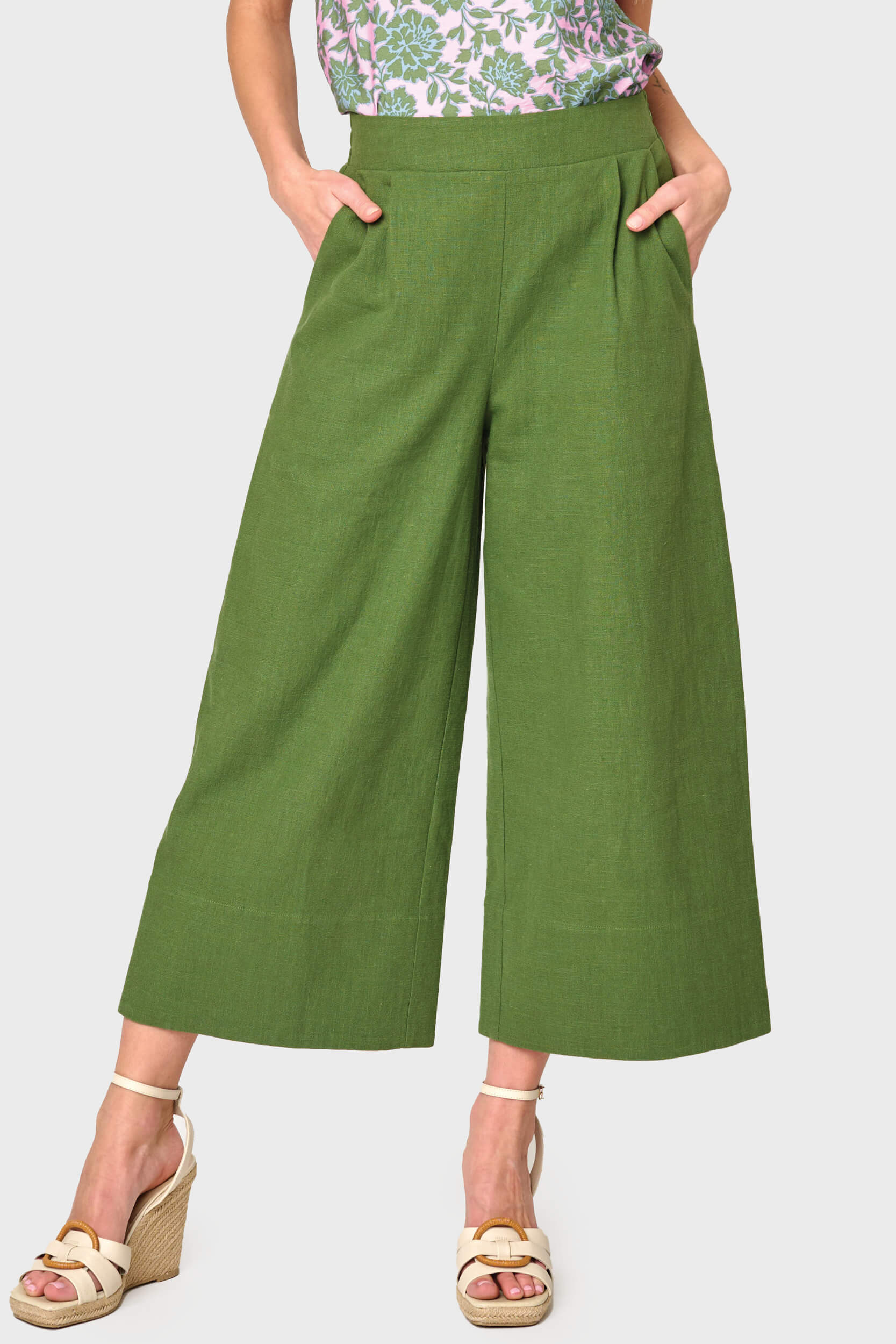 Woman modeling Wide Hem Cropped Linen Pant in Olive styled with blouse and sandals