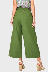 Back view of Woman modeling Wide Hem Cropped Linen Pant in Olive styled with blouse and sandals