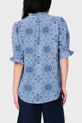 Back view Women modeling Dianthus Henley Puff Sleeve Blouse in Bandana Blue print style with linen pants