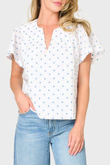 Woman modeling Flutter Sleeve Blouse With Open Yoke in White Denim Dot styled for everyday