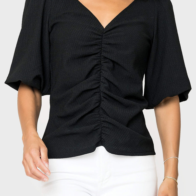 Front of women wearing the Balloon Sleeved V-Neck Textured Top in black