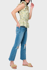 Side view of Woman modeling Elle Boho Flutter Sleeve Top in Secret Garden Print print styled with denim