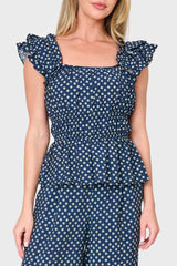 Woman modeling Elle Boho Flutter Sleeve Top in Navy daisy dot print styled as a set