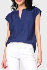 Woman modeling Cap Sleeve Notch Neck Blouse in Navy blue styled for summer work