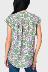 Back view of Woman modeling Cap Sleeve Notch Neck Blouse in Rose Garden print styled with denim pants