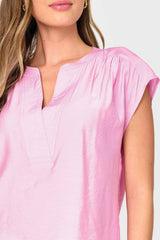 Woman modeling Cap Sleeve Notch Neck Blouse in Lilac pink split neck details