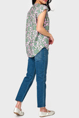 Side view of Woman modeling Cap Sleeve Notch Neck Blouse in Rose Garden print styled with denim pants