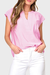 Woman modeling Cap Sleeve Notch Neck Blouse in Lilac pink styled with business casual