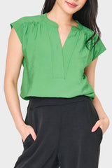 Woman modeling Cap Sleeve Notch Neck Blouse in green styled for everyday work to weekend
