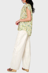 Side view of Woman modeling Cap Sleeve Notch Neck Blouse in Secret Garden Floral styled business casual